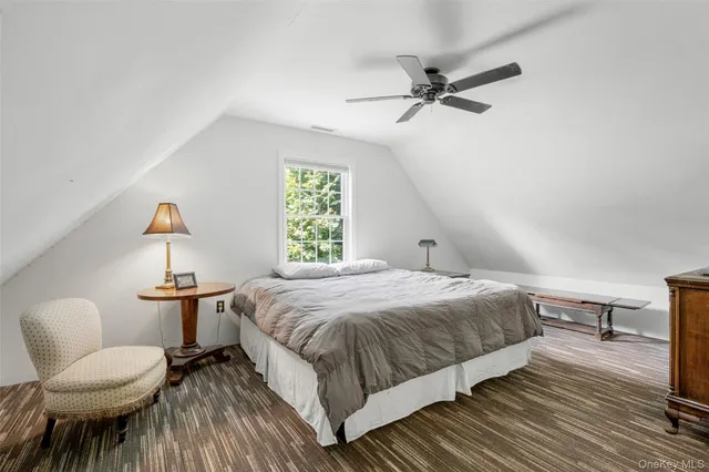 a bedroom with a large bed and a dresser