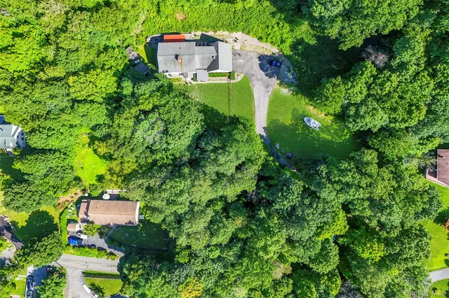 an aerial view of a house with a yard