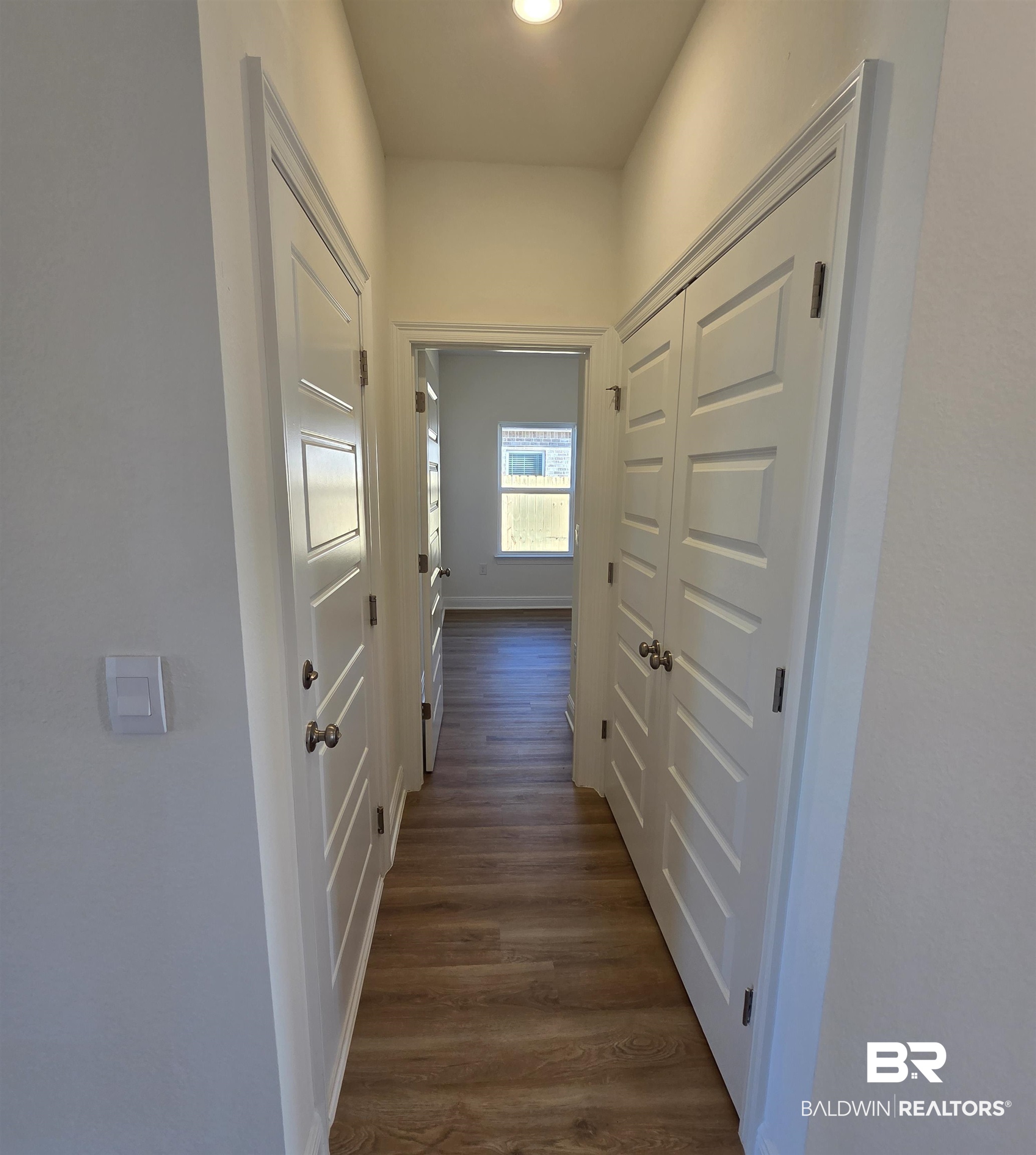 28084 Hallow Trail Elberta, AL 36530 - Photo 11 of 21 Hallway featuring dark wood finished floors