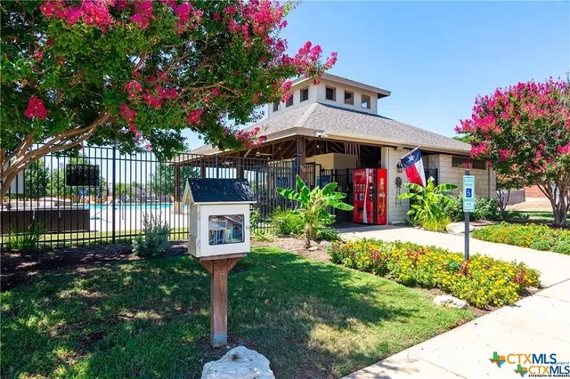an aerial view of residential houses with outdoor space and street view