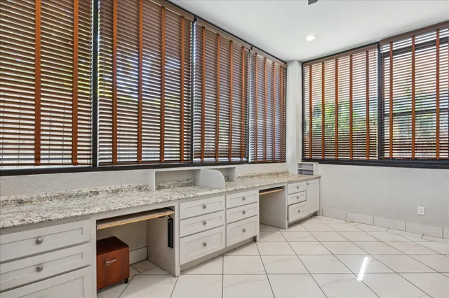 a bathroom with a granite countertop sink and a large mirror