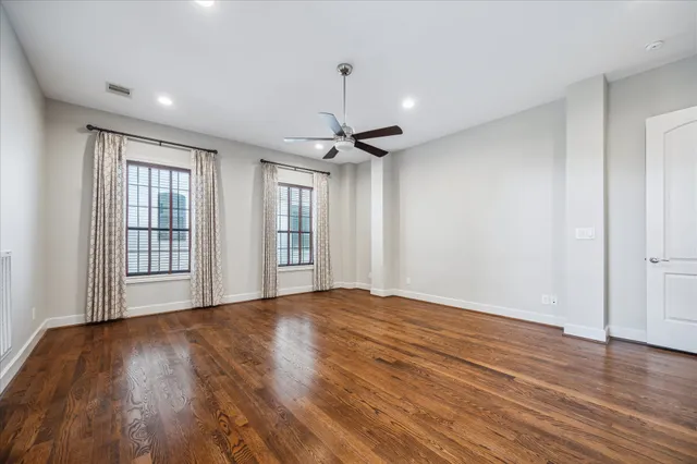 a bedroom with a bed a chandelier and a rug