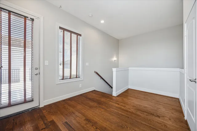 a spacious bathroom with a granite countertop sink a toilet a mirror and shower