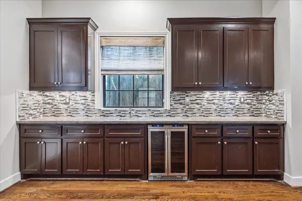 a kitchen with granite countertop a sink and cabinets