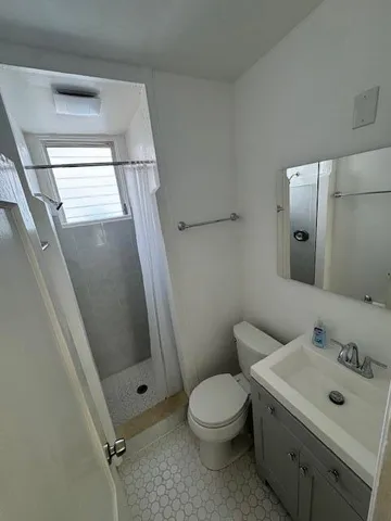 a bathroom with a sink mirror vanity and toilet