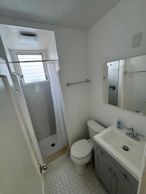4605 Georgia Avenue, Unit C West Palm Beach, FL 33405 - Photo 3 of 8 a bathroom with a sink mirror vanity and toilet