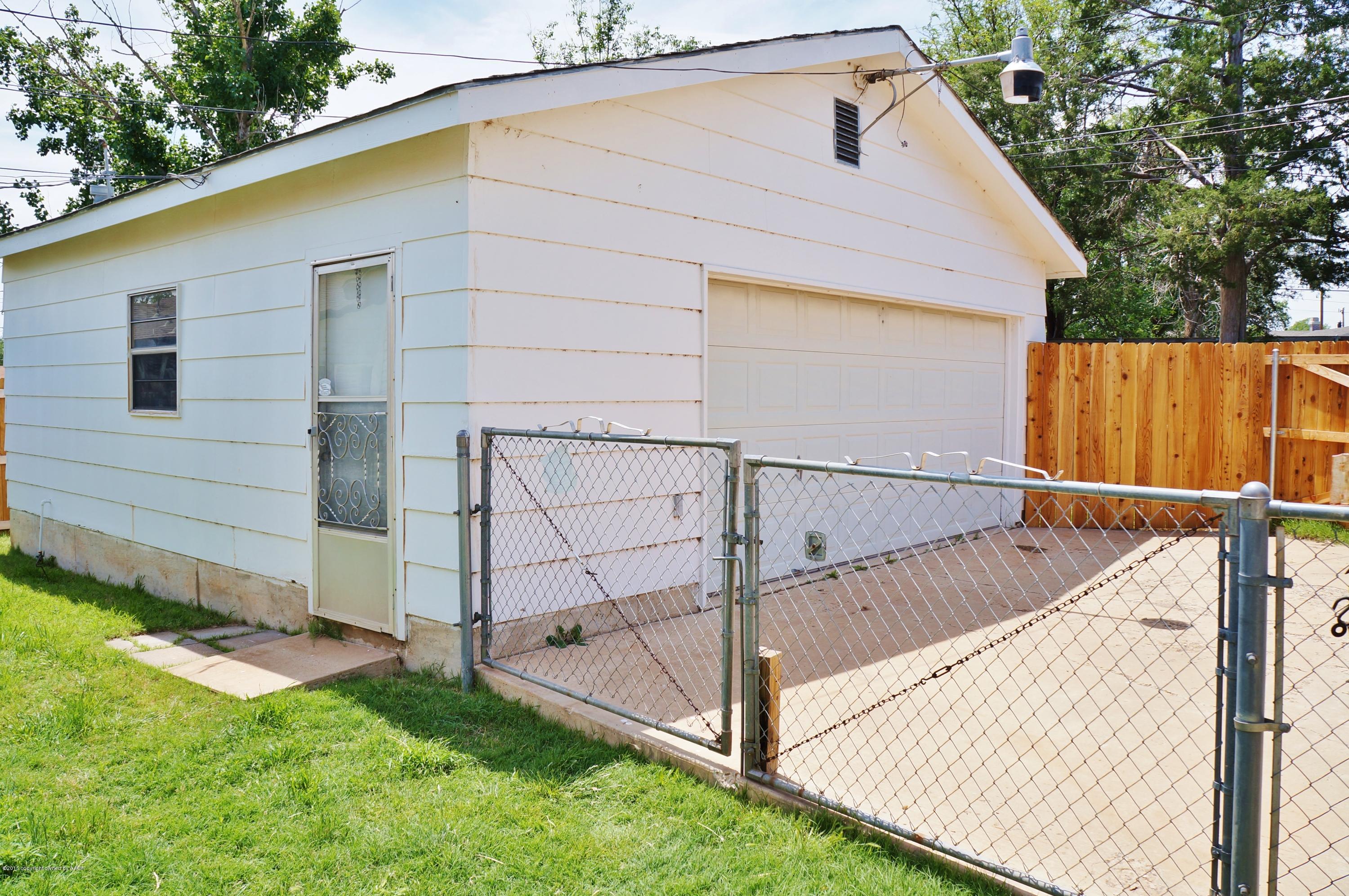 4902 South Parker Street Amarillo, TX 79110 - Photo 14 of 15 a view of backyard with small cabin and wooden fence