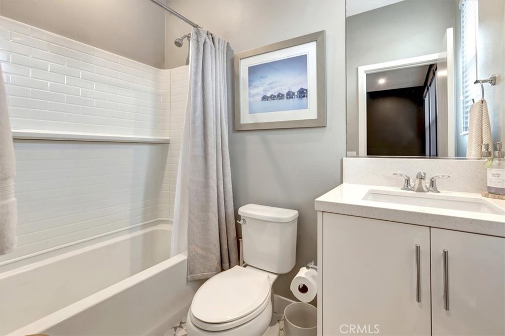 1810 West Bushell Street Anaheim, CA 92805 - Photo 23 of 36 a bathroom with a toilet sink and mirror