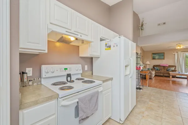 a kitchen with a sink a stove and a refrigerator