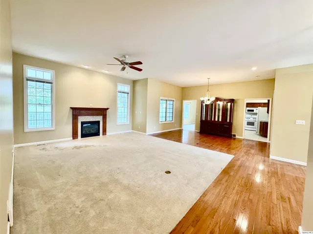 a spacious bedroom with a bed and a fireplace