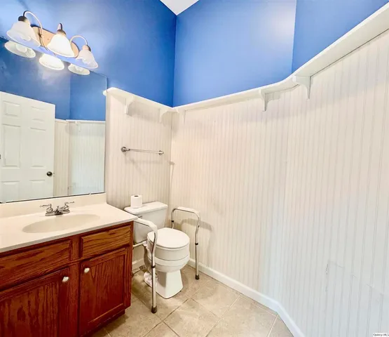 a bathroom with a sink a toilet and a mirror