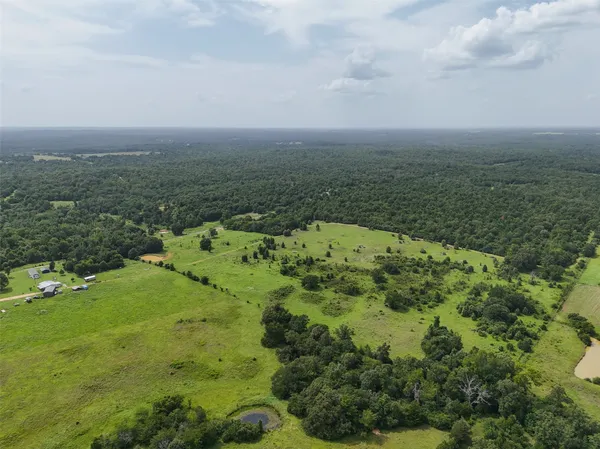 an aerial view of a houses with yard