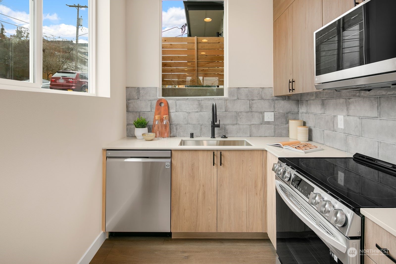 210 16th Avenue South Seattle, WA 98144 - Photo 5 of 17 a kitchen with stainless steel appliances a sink stove and cabinets