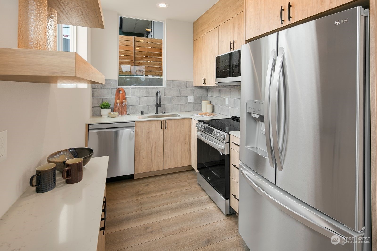 210 16th Avenue South Seattle, WA 98144 - Photo 6 of 17 a kitchen with stainless steel appliances a refrigerator sink and wooden cabinets