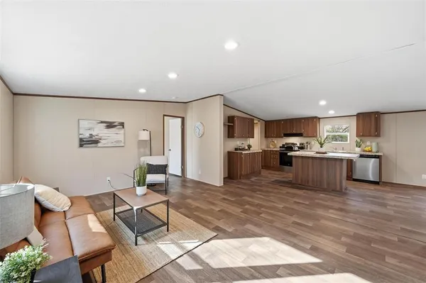 a living room with furniture and kitchen view