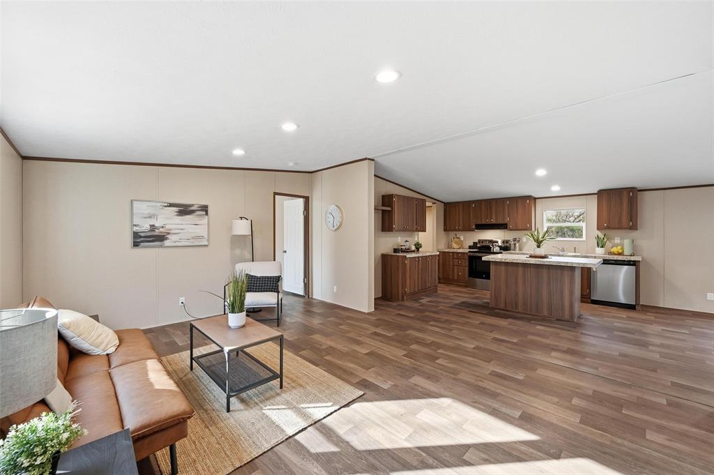 a living room with furniture and kitchen view