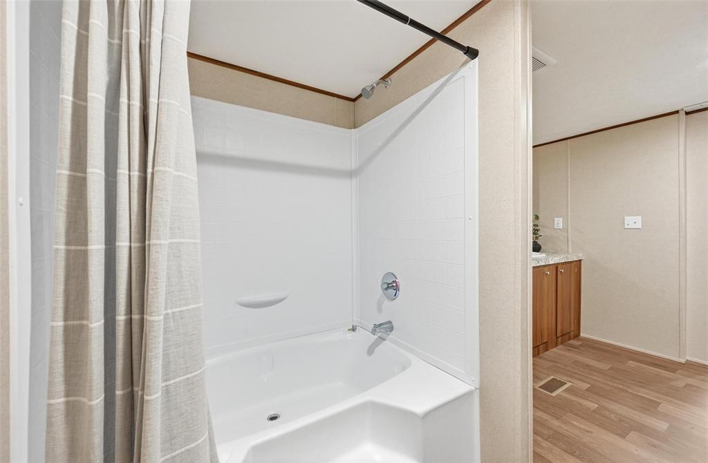 279 Carlisle Court Springtown, TX 76082 - Photo 12 of 22 a bathroom with a bathtub and a shower