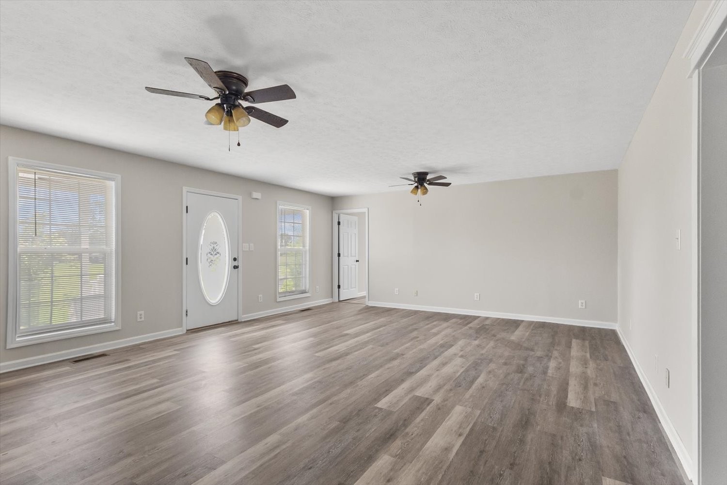 535 Darbytown Road Hohenwald, TN 38462 - Photo 15 of 45 an empty room with wooden floor and windows