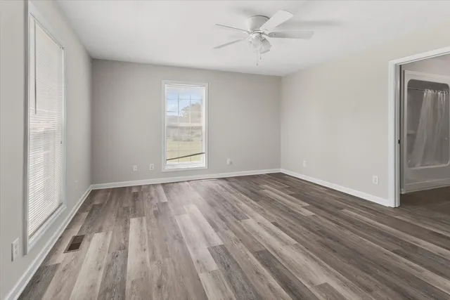wooden floor in an empty room with a window