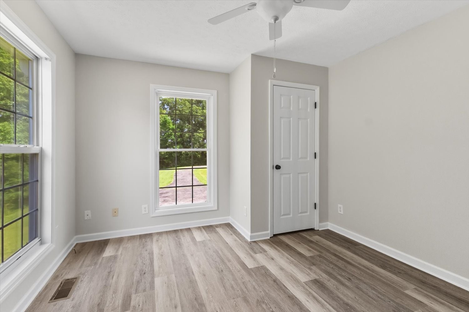 535 Darbytown Road Hohenwald, TN 38462 - Photo 22 of 45 an empty room with wooden floor and windows