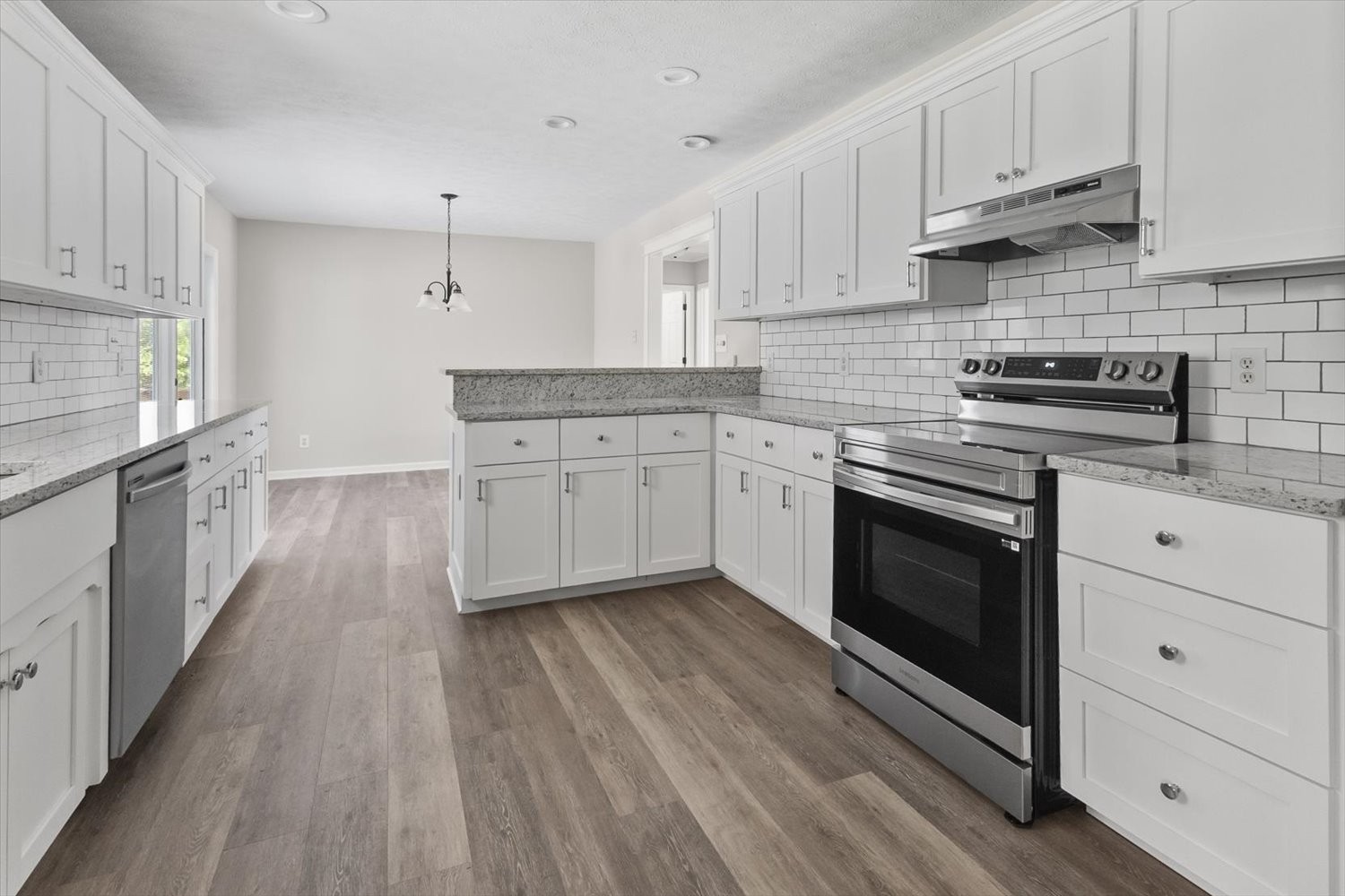 535 Darbytown Road Hohenwald, TN 38462 - Photo 29 of 45 a kitchen with cabinets wooden floor and stainless steel appliances