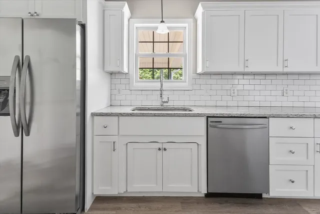 a kitchen with appliances cabinets and a sink