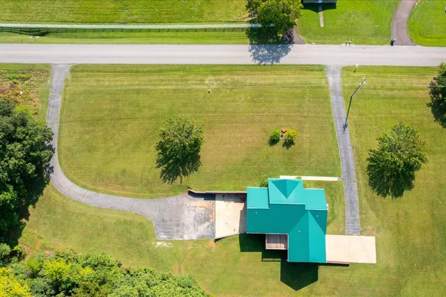 a view of a swimming pool with a yard