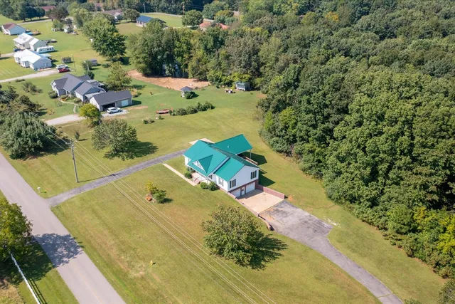 an aerial view of a house with a yard