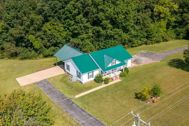 an aerial view of a house with a yard