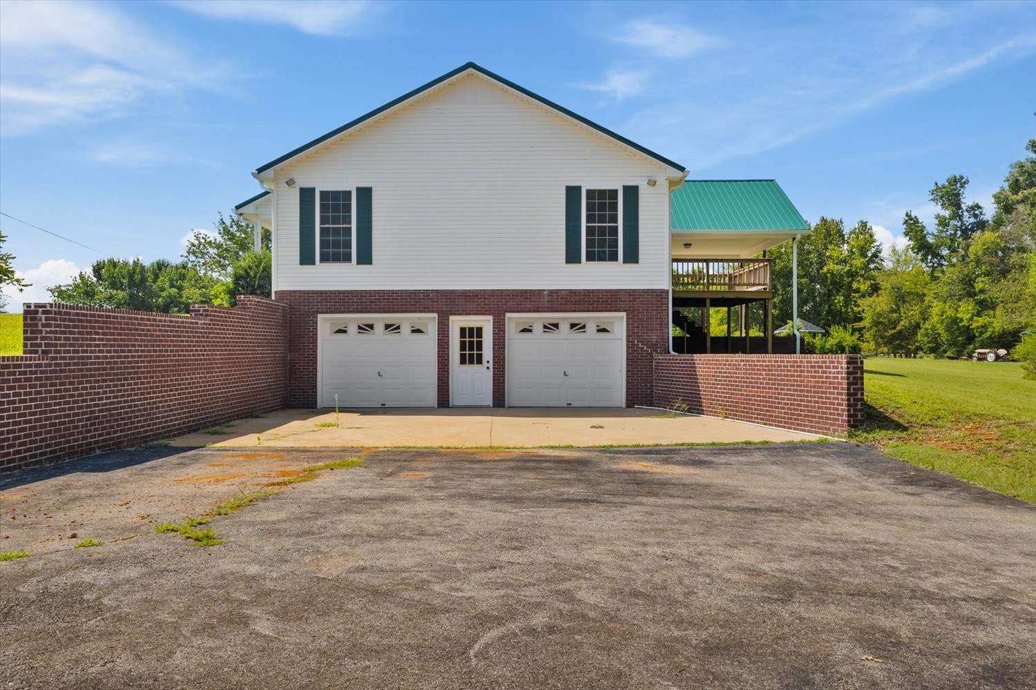 535 Darbytown Road Hohenwald, TN 38462 - Photo 5 of 45 a front view of a house with a yard and garage