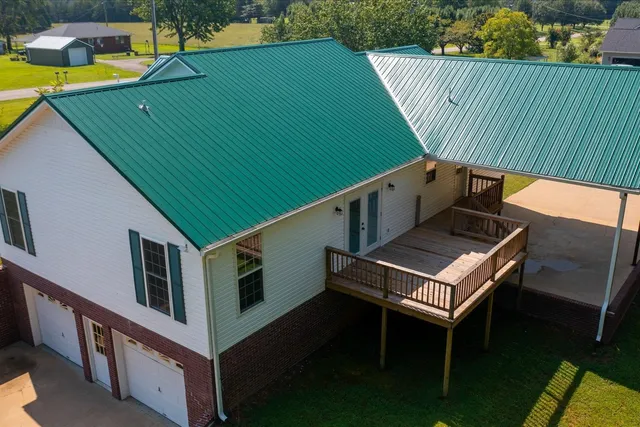 a roof deck with table and chairs and wooden floor