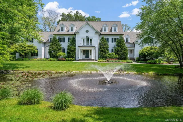 a front view of a house with a yard and trees