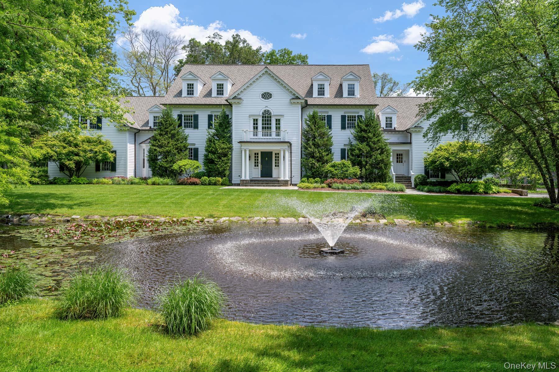 a front view of a house with a yard and trees