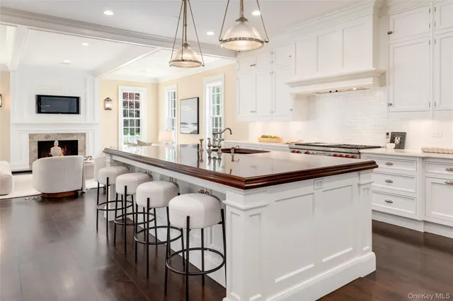 a kitchen with stainless steel appliances a stove a sink and a refrigerator