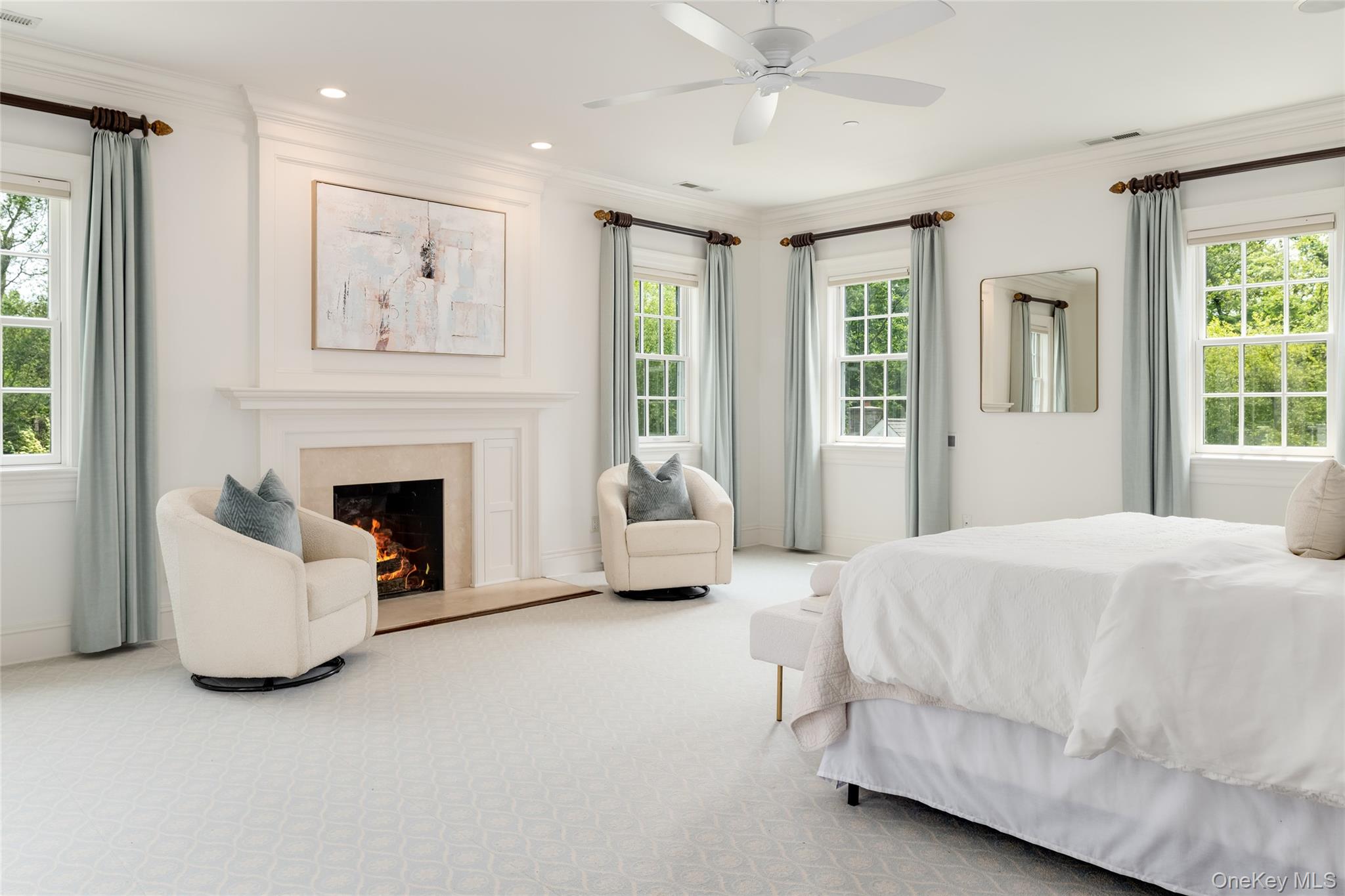 21 Dorann Road Purchase, NY 10577 - Photo 25 of 39 a bedroom with a white bed couches and a fireplace