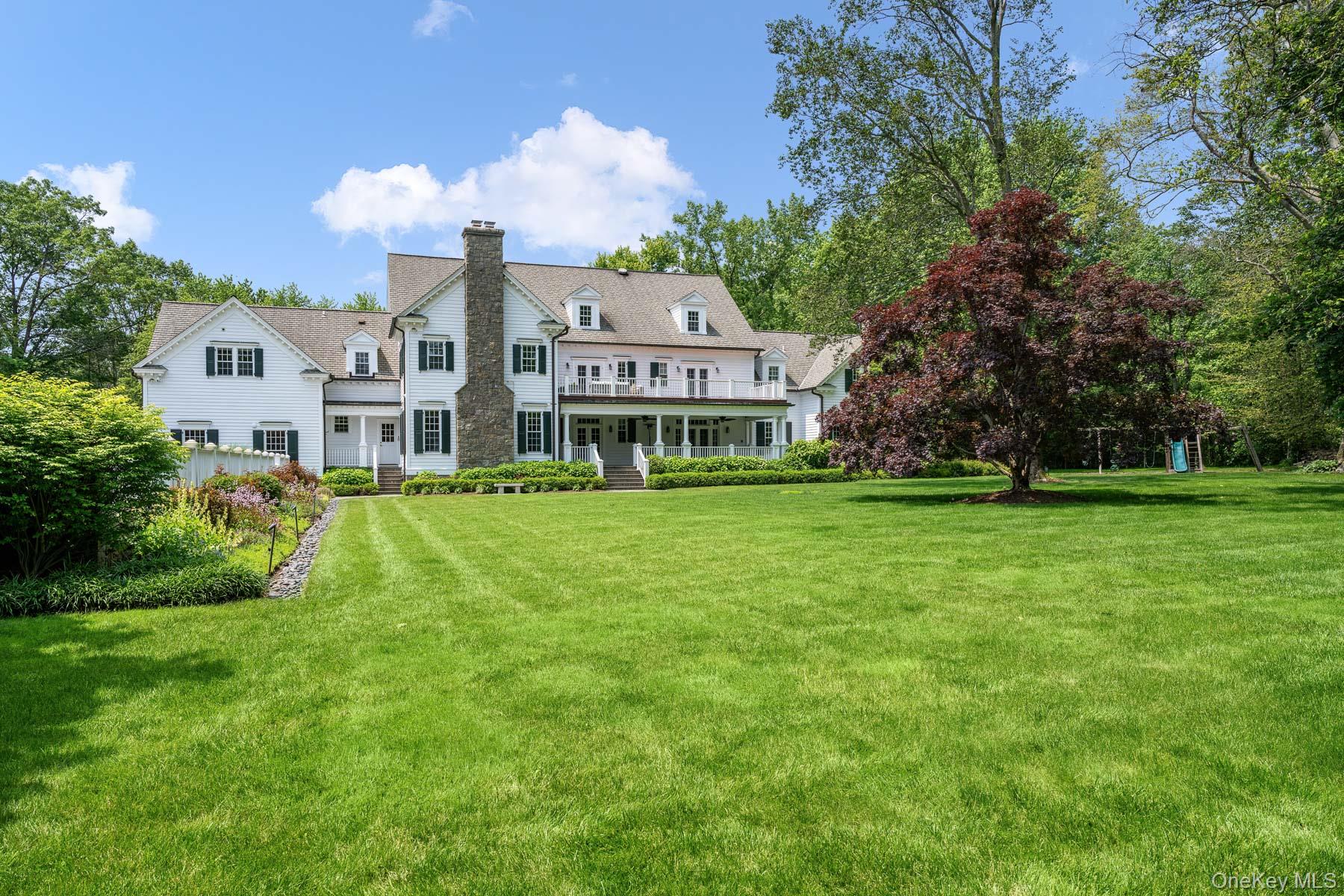 21 Dorann Road Purchase, NY 10577 - Photo 28 of 39 a view of a house with a big yard potted plants and large trees