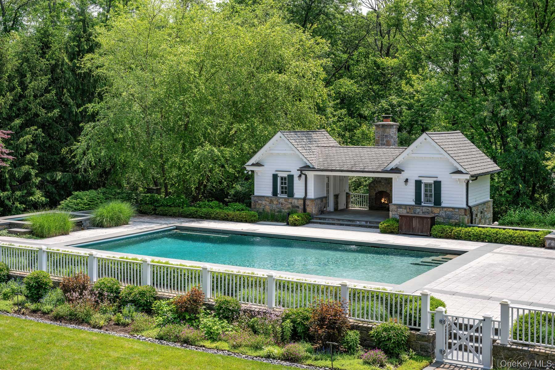 21 Dorann Road Purchase, NY 10577 - Photo 34 of 39 a view of a house with swimming pool and a yard