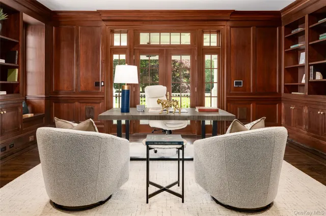 a dining room with furniture and a floor to ceiling window