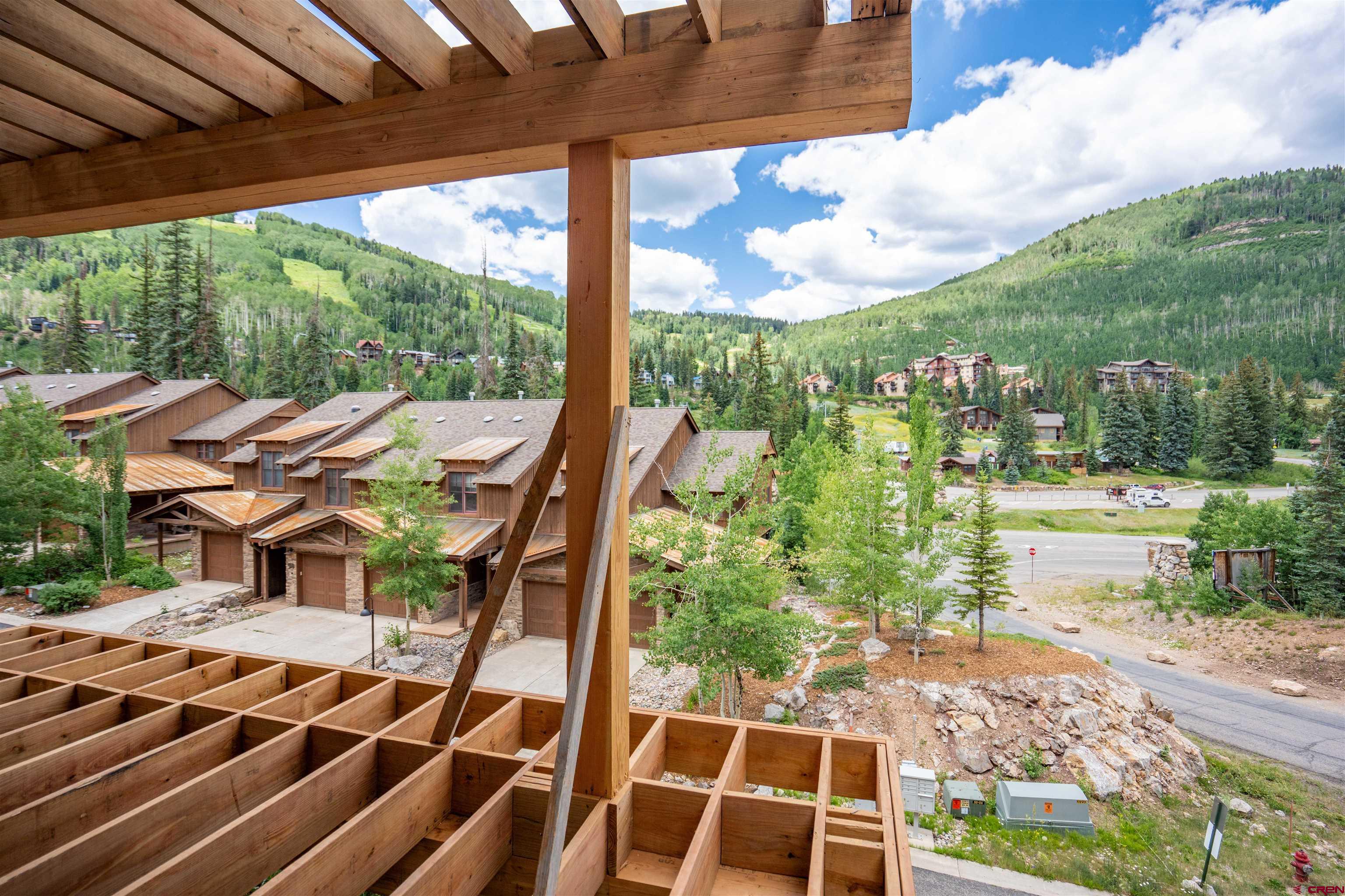 89 Travertine Trail Durango, CO 81301 - Photo 18 of 27 a view of a patio with table and chairs and wooden floor