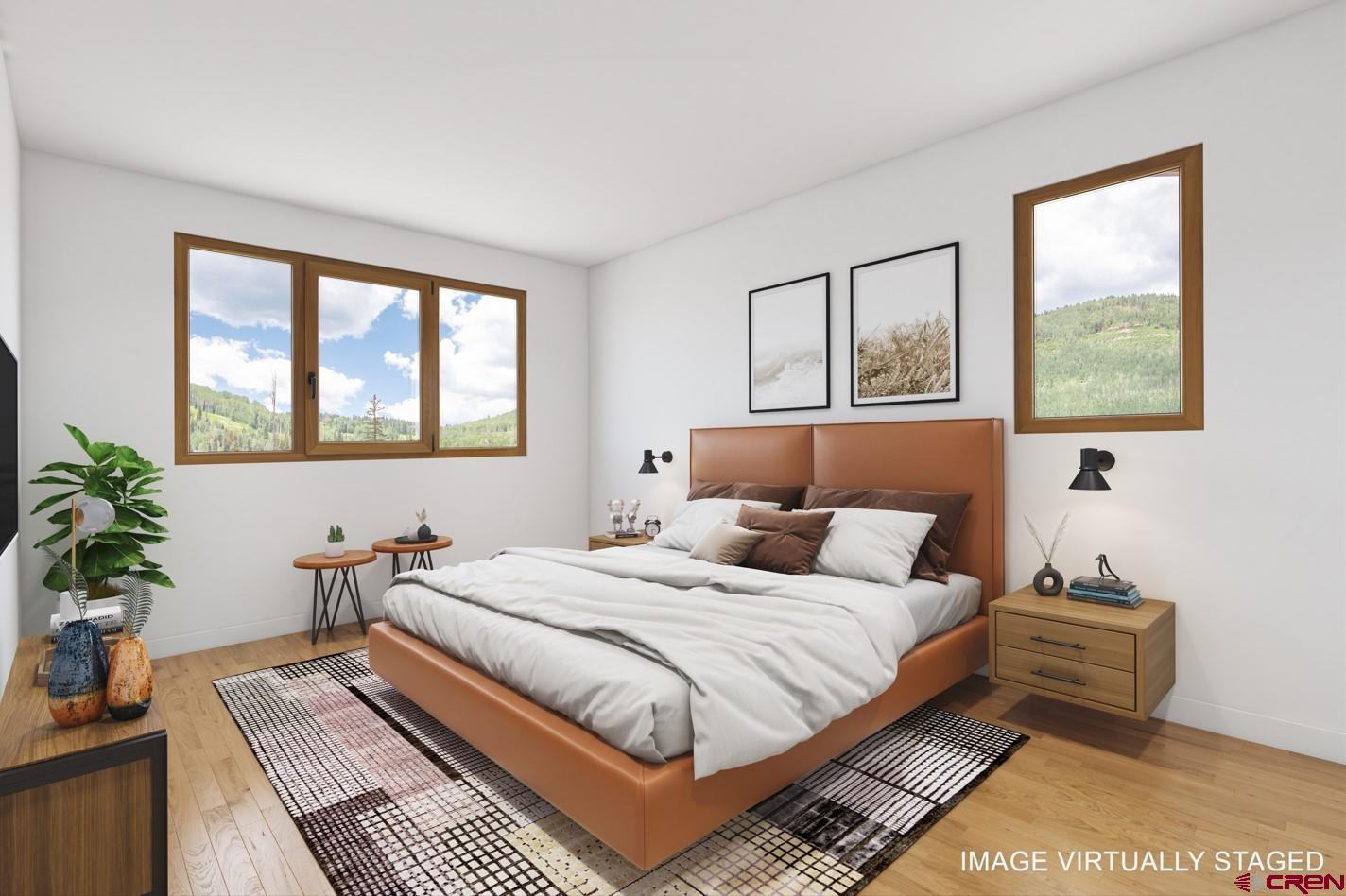 89 Travertine Trail Durango, CO 81301 - Photo 4 of 27 a bedroom with a bed and wooden floor