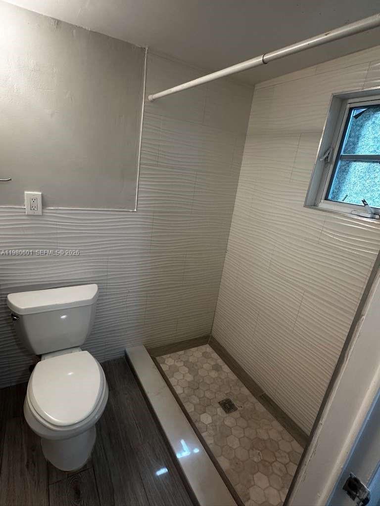 6837 Southwest 39th Terrace, Unit B Miami, FL 33155 - Photo 11 of 16 a bathroom with a toilet and a shower