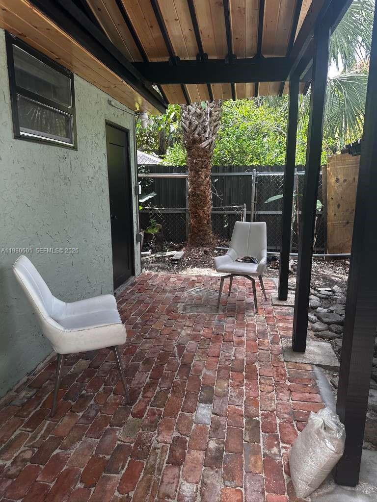 6837 Southwest 39th Terrace, Unit B Miami, FL 33155 - Photo 15 of 16 a chairs and a table in a patio