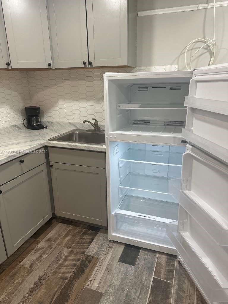 6837 Southwest 39th Terrace, Unit B Miami, FL 33155 - Photo 5 of 16 a kitchen with a sink and cabinets