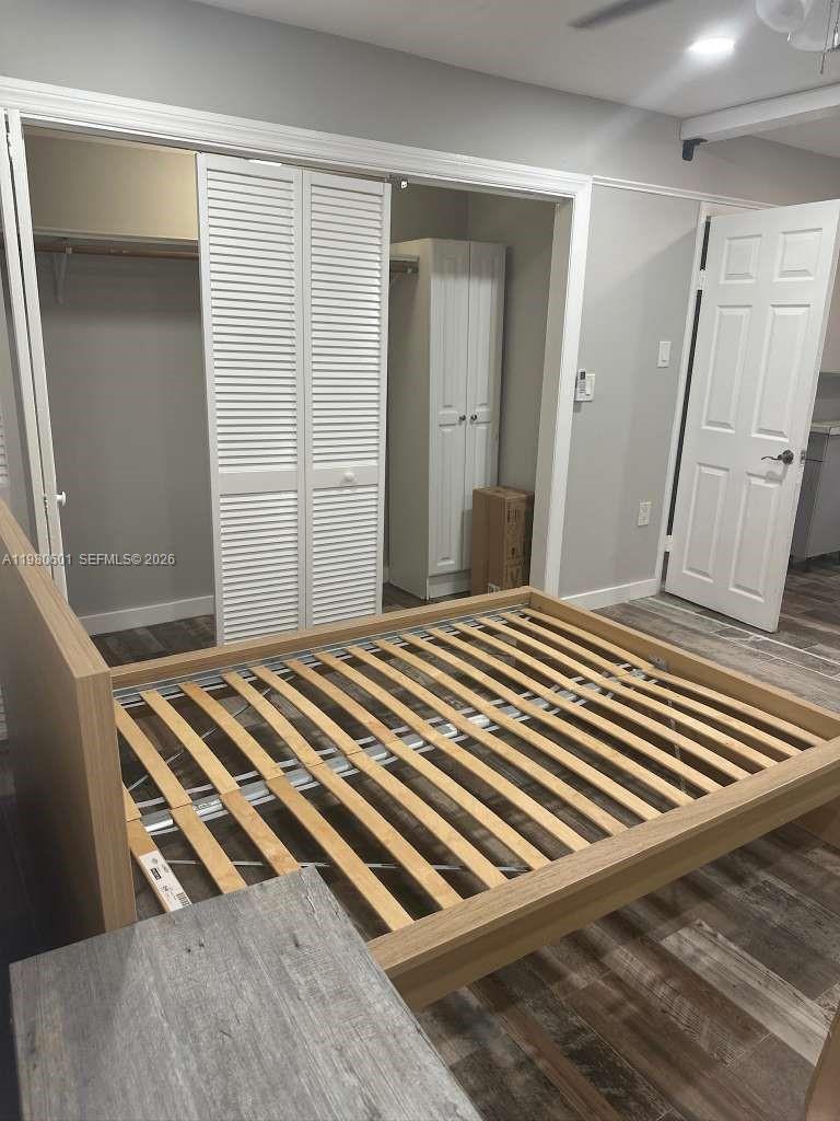 6837 Southwest 39th Terrace, Unit B Miami, FL 33155 - Photo 6 of 16 a bedroom with a bed and wooden floor