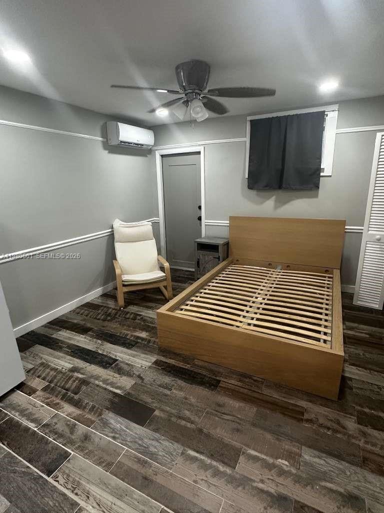 6837 Southwest 39th Terrace, Unit B Miami, FL 33155 - Photo 7 of 16 a bedroom with a bed and a chandelier