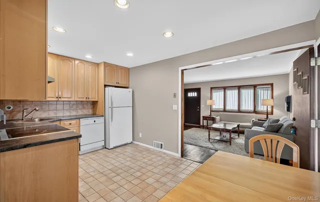 a kitchen with a refrigerator and a sink