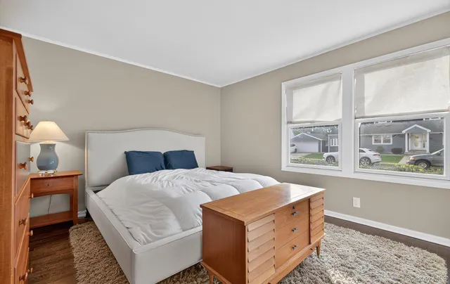 a bedroom with a large bed and a window