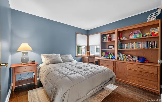 a bedroom with a bed and a book shelf