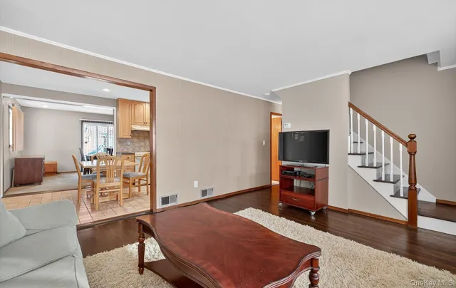 a bedroom with furniture and a flat screen tv