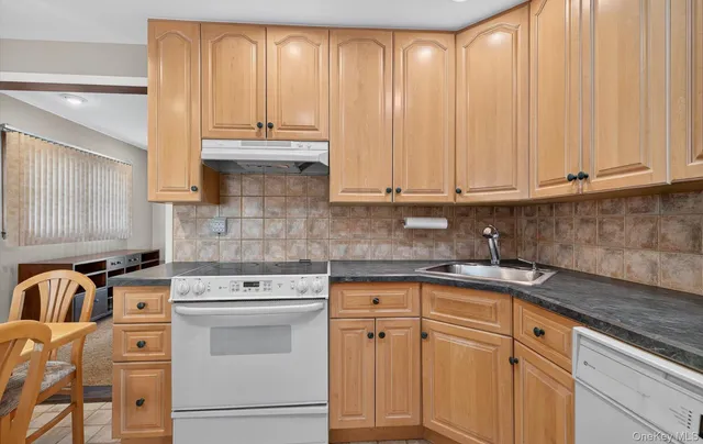 a kitchen with stainless steel appliances granite countertop a sink stove and cabinets